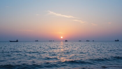 Tranquil Sunset Over the Ocean with Fishing Boats in the Distance
