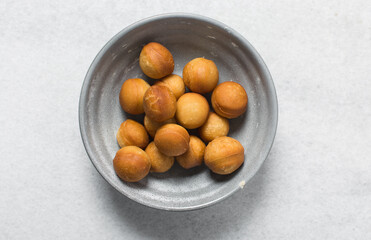 Overhead view of donut holes, top view of homemade doughnut holes on a white background, process of making doughnuts