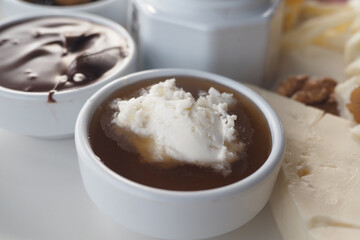 Creamy dessert dip served alongside assorted sweet toppings