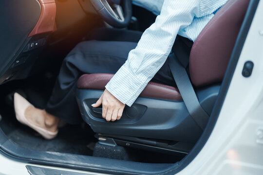 Business woman hand adjust car seat before drive on the road. Ergonomic, health  care and safety transportation concept