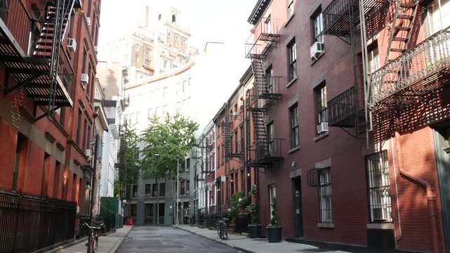 New York City classic building architecture. Urban residential house exterior. Real estate property in USA. Typical red brick facade. Greenwich Village Gay street. Fire escape, emergency ladder exit.