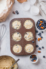 The dough and blueberries are placed in a baking dish