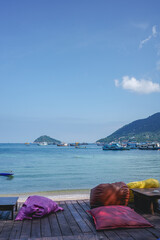 A cafe with beautiful scenery by the beach overlook the blue ocean in Koh Tao, Thailand. A famous summer holiday destination for relaxing, family, and couples