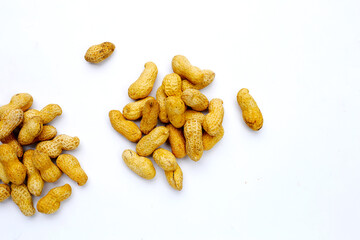 Roasted peanuts in shell on white background.
