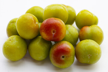 Fresh green plum on white background