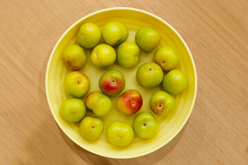 Fresh green plum on white background