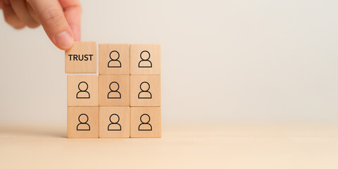 Business trust and success concept. Wooden blocks with trust, teamwork, customer, business partner...