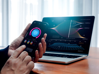 AI data analysis tools technology, research system with artificial intelligence, business analytics concept. Digital info dashboard on smartphone in businessman hand while work with laptop computer.