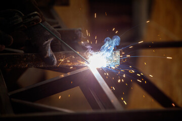 A man is welding a piece of metal
