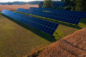 Solar panels installed alongside golden wheat fields demonstrate renewable energy integration with...