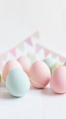 Colorful Easter eggs arranged on a table, featuring pink and green designs.