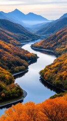 Naklejka premium Winding river flowing through colorful autumn valley in the mountains