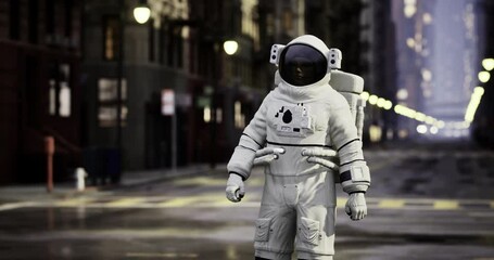 An astronaut stands alone on a quiet city street early in the morning. The surroundings are empty, with buildings lining the road and streetlights illuminating the scene.