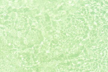 Blue water with ripples on the surface. Defocus blurred transparent blue colored clear calm water surface texture with splashes and bubbles. Water waves with shining pattern texture background.