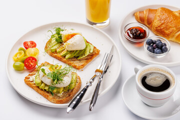Breakfast with delicious avocado toasts and crispy croissant