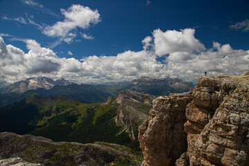 Hiker enjoys the view from Lagazuoi mountain over the italian Dolomites.