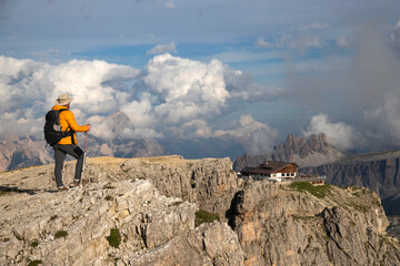 Obraz premium Hiker enjoys the view from Lagazuoi mountain over the italian Dolomites.