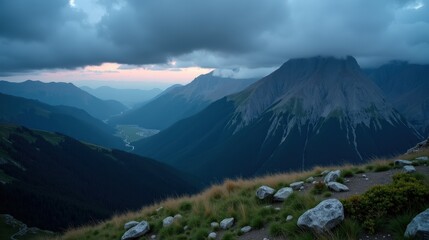 Fototapeta premium The Apennines (Gran Sasso d’Italia, Majella) during dusk with rainy weather, captured from a panoramic perspective, featuring misty mountains and a dynamic sky.