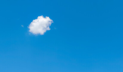 Single Cloud in Blue Sky: A small, white cloud floats against a clear, bright blue sky