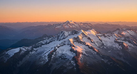 Obraz premium Snowy Mountain Peaks at Golden Hour Sunrise Landscape Aerial View