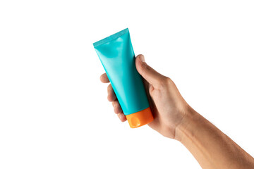 Male hand holding a cyan and orange sunscreen bottle isolated no background
