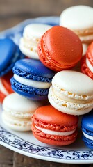 Fototapeta premium Elegant red, white, and blue macarons on a decorative plate