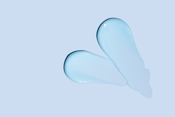 blue cosmetic cream texture, skincare lotion swatch on blue background. Face creme, body moisturizer, hair conditioner smear smudge stroke. Creamy beauty product closeup