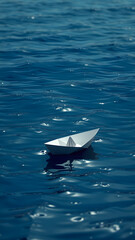 Fototapeta premium Paper boat floating on calm water, peaceful and minimalist scene. Conceptual image symbolizing childhood, simplicity, and serenity.