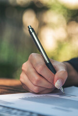 Vertical Horizon Businesswoman hands note meeting document conference room. Woman Hands writing...