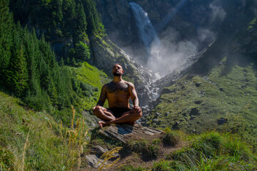 Man, breathing and relax with peace in nature. Meditation, spiritual wellness. Calm, athlete and freedom in environment. Training mindfulness. Relaxed man in nature. Freedom and happiness lifestyle.