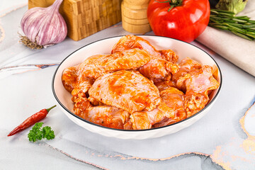 Raw marinated uncooked chicken wings