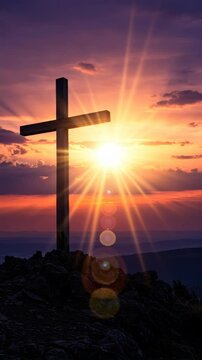 Wooden cross on a hill at sunset, vertical footage
