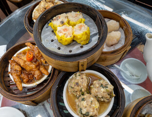 A selection of popular Cantonese Dim Sum dishes served during yum cha in a Hong Kong tea house.