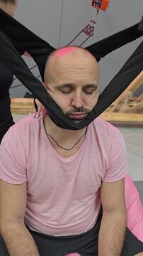 Doctor performing cervical spine traction therapy on patient