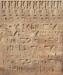 Ancient Egyptian hieroglyphs on stone wall, Karnak Temple Complex, Luxor, Egypt, Africa. Stone carvings with hieroglyphs at Karnak temple, Luxor, Thebes