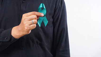 Man holding green ribbon in front oh his chest as symbol of kidney disease awareness isolated on...