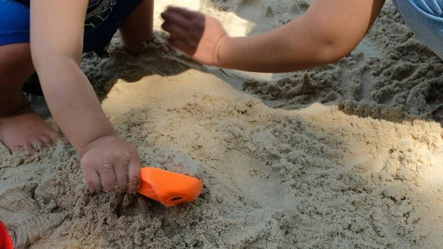 ren playing in the sand at the beach