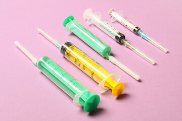 Top view of medical syringes on colorful background with copy space. Injection equipment concept