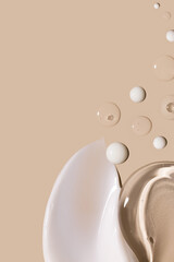 creamy texture of cosmetic samples on a pastel beige background