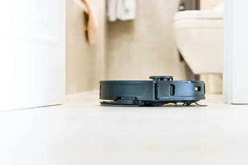 Robot vacuum cleaner performs automatic cleaning of the apartment at a certain time. Smart home....