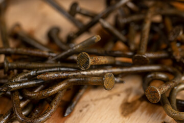 old broken and bent steel nails covered with rust