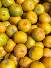 Portrait of fresh oranges neatly stacked in a supermarket, showcasing their vibrant color and natural freshness. Alam Sutera, Indonesia - March 15, 2025