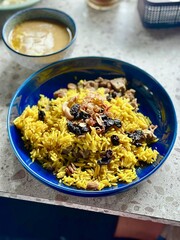 Golden Nasi Mandhi with dates and tender lamb, served with a separate lamb curry – a perfect dish for Iftar or Eid Mubarak celebrations.Alam Sutera, Indonesia - March 16, 2025.