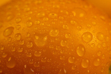 a large number of ripe orange tomatoes that are on the table