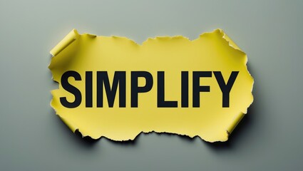 Word "Simplify" displayed on a yellow sheet of paper.