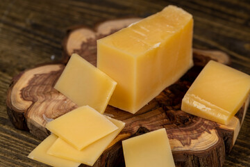 a piece of sliced hard mature cheese in close-up