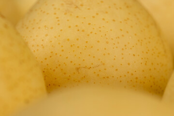 ripe white pear with a yellow colour on the table