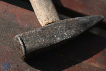 Workshop tools, old worn out hammer
