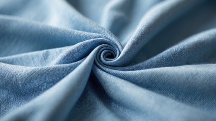 Close-up of textured light blue denim material. Soft, gentle folds and wrinkles highlight the weave of the fabric.