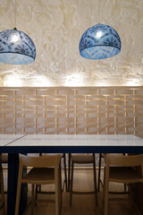 Interior design and decoration at European restaurant decorated with wooden furniture and tiles